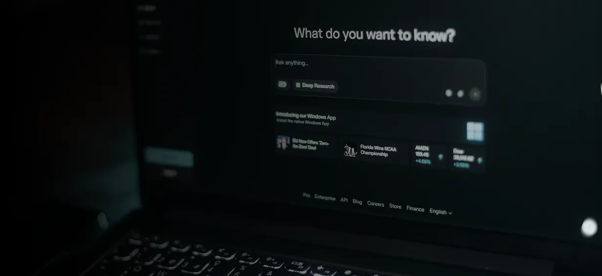 Friendly AI assistant robot beside a smartphone, representing adaptive AI agents for modern workflows.